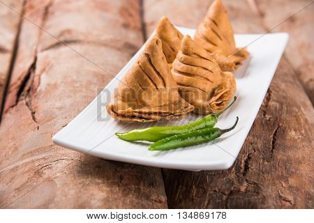 Samosa snack with tomato ketchup and hot tea, Fresh samosas with ketchup and hot chai ready for breakfast