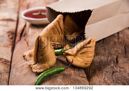 Samosa snack with tomato ketchup and hot tea, Fresh samosas with ketchup and hot chai ready for breakfast