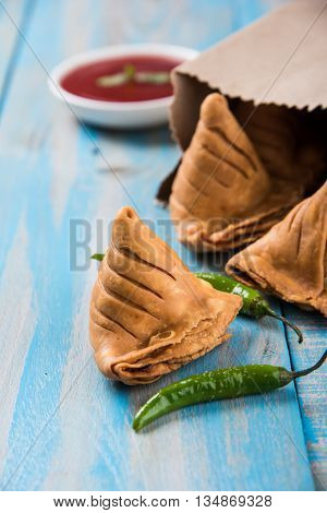 Samosa snack with tomato ketchup and hot tea, Fresh samosas with ketchup and hot chai ready for breakfast
