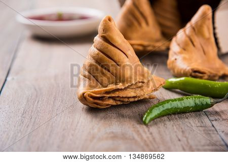 Samosa snack with tomato ketchup and hot tea, Fresh samosas with ketchup and hot chai ready for breakfast