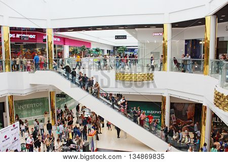 Chernihiv / Ukraine. 09 May 2016:  people going for shopping on the escalator in the supermarket in Chernihiv. 09 May 2016 in Chernihiv / Ukraine.
