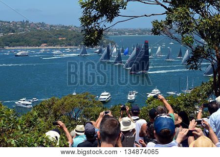 Sydney, Australia - December 26, 2014. Spectators are watching the race from Mosman. The Sydney to Hobart Yacht Race is an annual event, starting in Sydney on Boxing Day and finishing in Hobart.