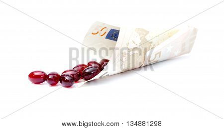 Krill oil capsules spill out from euro banknote