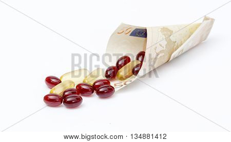 Krill oil capsules spill out from euro banknote