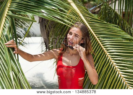 Woman on the beach in the red swimwear