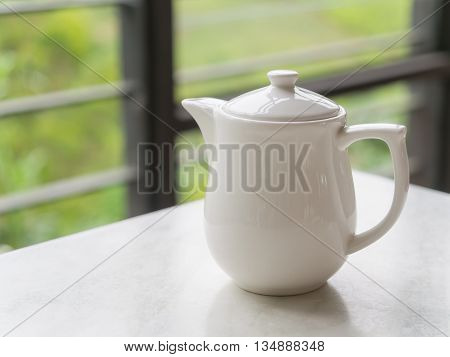 White teapot on the table at Boh Tea Plantation Cameron Highlands Malaysia