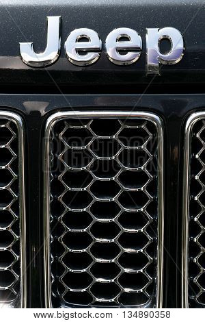 TURIN, ITALY - JUNE 9, 2016: Jeep logo on the front of a Cherokee model