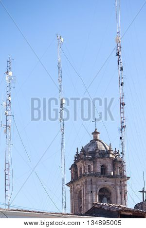 Cellular towers juxtaposed with Spanish colonial cathedral bell tower