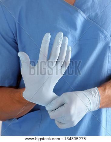 Doctor in blue uniform holding X-rays. clinic