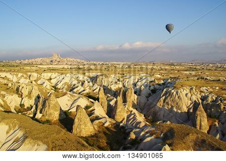 Solitary balloon over the geologic formations of Cappadocia