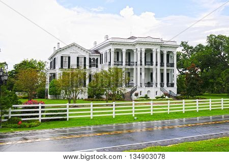 A beautiful Italianate plantation mansion sits among a forest of ancient Live Oaks on a Louisiana plantation