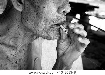 Elderly man smoking in mouth vintage tone
