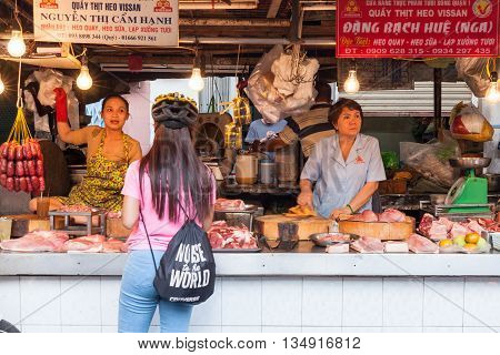 HO CHI MINH CITY VIETNAM - FEBRUARY 07: Women are selling meat at the wet market on February 07 2016 in Ho Chi Minh City Vietnam.