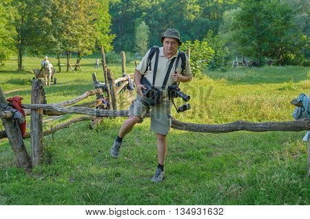 Tired mature photographer going back home after outdoor photo session
