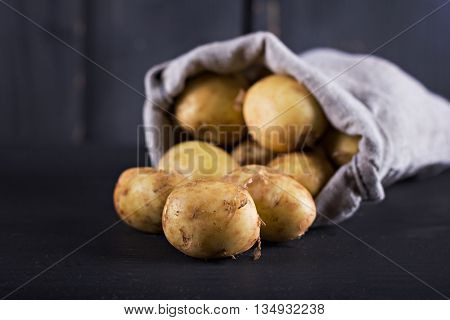 new potatoes on a dark old background.