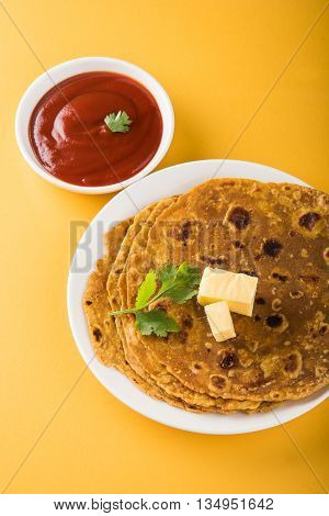 Hot delicious paratha with ghee and tomato sauce