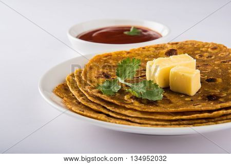 Hot delicious paratha with ghee and tomato sauce