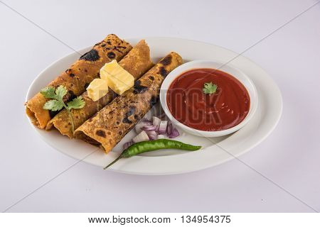 Hot delicious paratha with ghee, green chilly, coriander and tomato sauce. Paratha Rolls. Chapati made using indian spices. Kolkata rolls