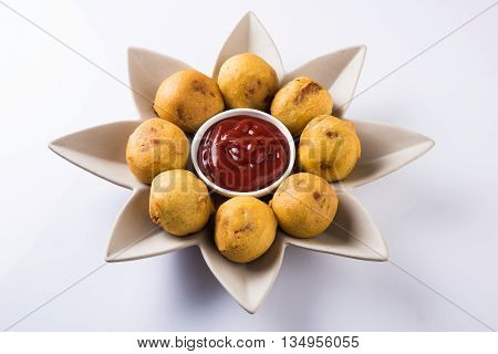 aalu bonda or aalo bonda or batata vada, indian tasty snack tastes great with tea, tea time snack, served with red tomato sauce