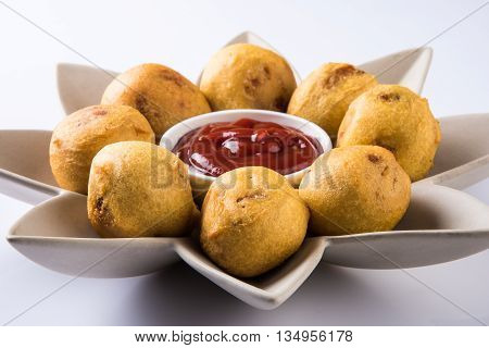 aalu bonda or aalo bonda or batata vada, indian tasty snack tastes great with tea, tea time snack, served with red tomato sauce