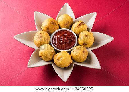 aalu bonda or aalo bonda or batata vada, indian tasty snack tastes great with tea, tea time snack, served with red tomato sauce