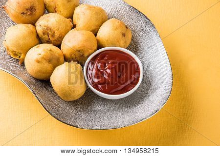 indian snacks also known as urad daal vada or indian pakoda or couth indian pakora or batata vada or aalu bonda or aalu bonde