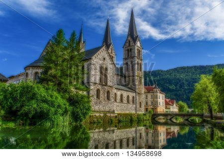 Saint Jernej church by river in Kočevje, Slovenia