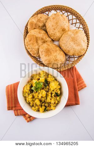 indian semi dry potato spicy recipe also known as aalu bhaji or aalu sabji served with indian puri or poori