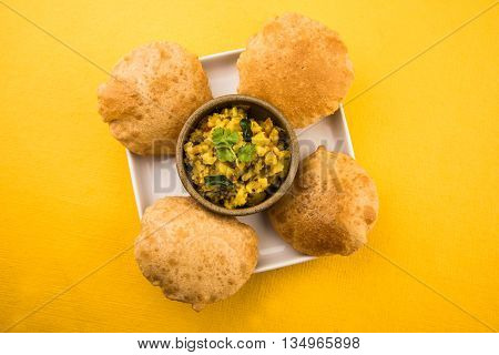 indian semi dry potato spicy recipe also known as aalu bhaji or aalu sabji served with indian puri or poori