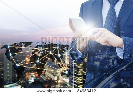 Double exposure of businessman touching with smart phone world business network connection and city center of business Technology communication business and finance concept world map from NASA