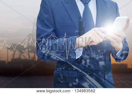 Double exposure of professional businessman using smart phone and city centre of business with blurred transportation port background Technology Transportation & Business trading concept