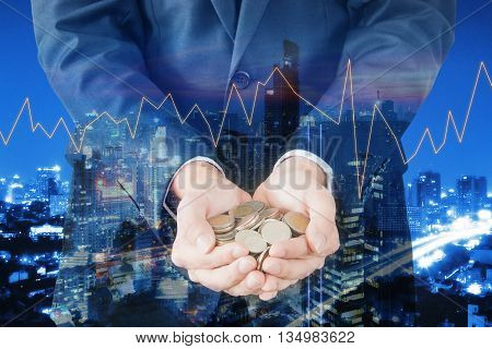 Double exposure of cityscape and businessman collect many coins on hands with trading graph finance and banking concept