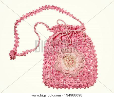 Knitted handmade pink Gift Bag with flower isolated