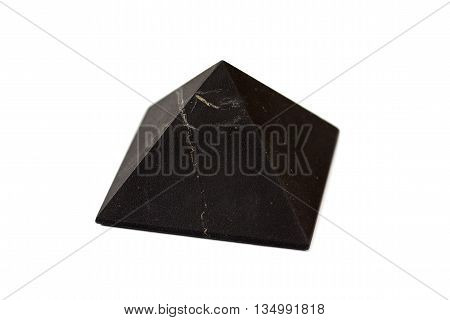A pyramid of shungite isolated on white background. Shungite Pyramid Mineral. Pyramid made of natural shungite.