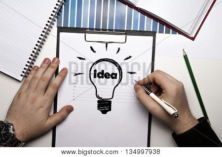 human hands and idea icon on a paper close up