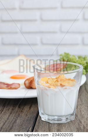 Close Up Breakfast Set With Bacon Fried Egg And Ham On Wooden Table Background