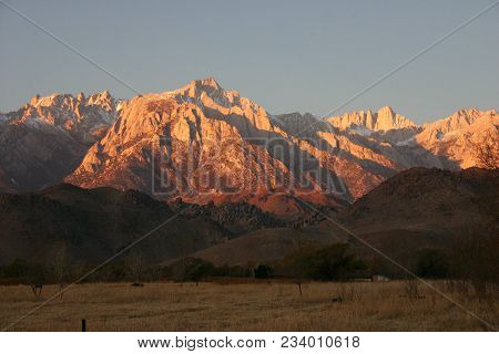 Snow-covered Mountain Tops In The Distance. The Sierra Nevada Is A Mountain Range In The Western Uni