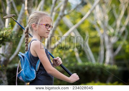 Happy Little Girl  Playing Mini Golf.