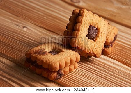 Stacked Chocolate Chip Cookies On A Light Wooden Background