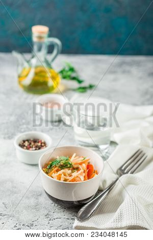 Cabbage Salad With Carrots, Tomatoes And Cucumbers In A Small Pial On A Light Table. Traditional Col