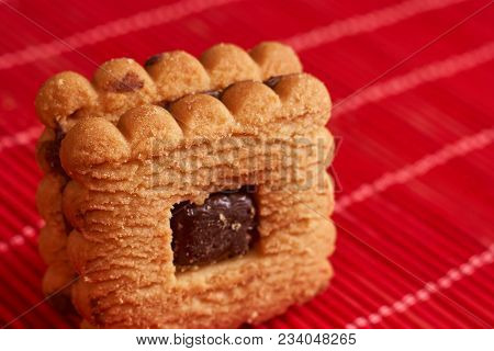 Stacked Chocolate Chip Cookies On Red Table