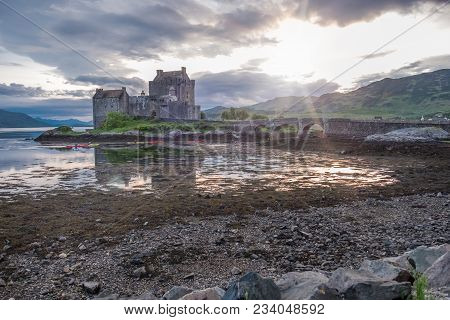 Eilean Donan Castle During Sunset While Canoes Passing By - Dornie, Scotland - United Kingdom