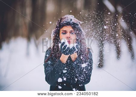 Girl Brunette Against The Background Of The Winter Forest