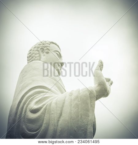 Statue Of Buddha Standing Hand Raised In Gesture Of Vitarka Mudra