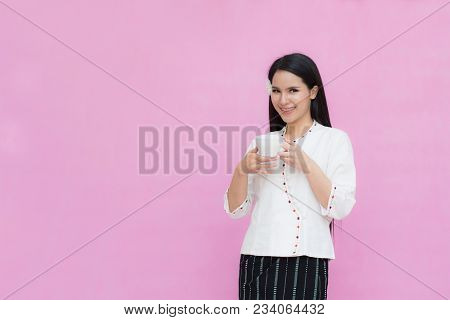 Portrait Beautiful Asian Girl In Traditional Thai Dress And Holding Coffee Cup Isolated On Pink Back