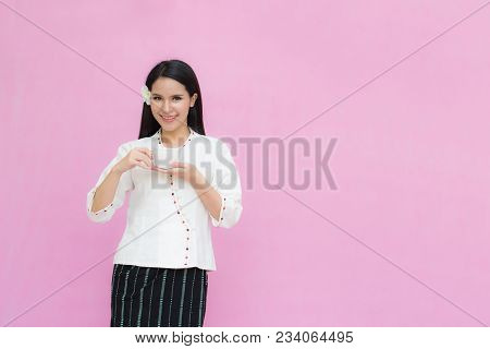 Portrait Beautiful Asian Girl In Traditional Thai Dress And Holding Coffee Cup Isolated On Pink Back