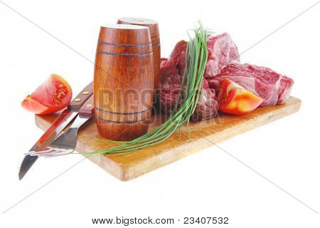 main course : fresh beef steak ready to prepare on cut board with cutlery and castor