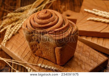 Beautiful Homemade Bread On A Textured Wooden Board. A Beautiful Combination Of The Color Of A Woode