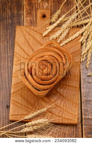 Fresh Homemade Garlic Bread On A Textured Wooden Board. Still Life With Fresh Bread And Spikelets.