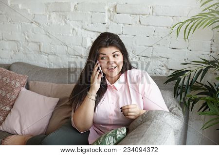 Human Emotions And Technologies Concept. Emotional Attractive Plus Size Female With Dark Hair Exclai